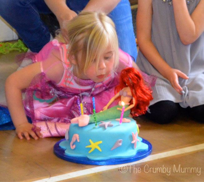 my little mermaid blowing out her candles