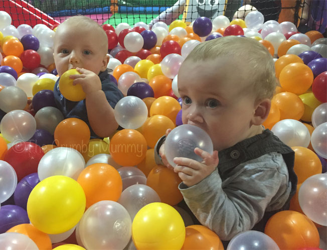 babies playing in a ball pool