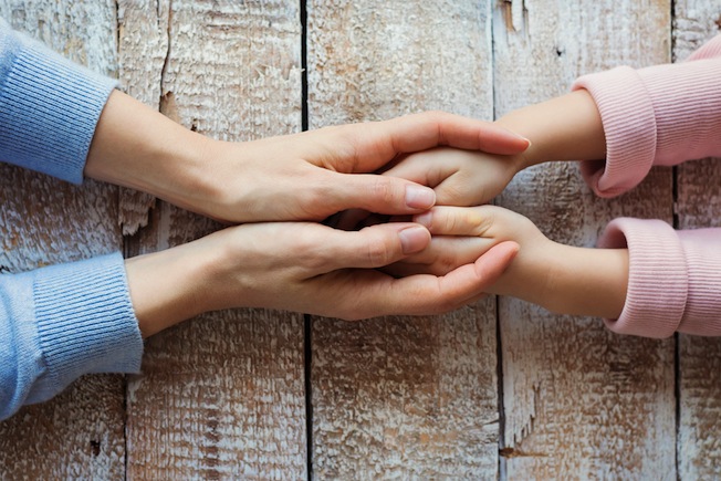 mummy and child holding hands